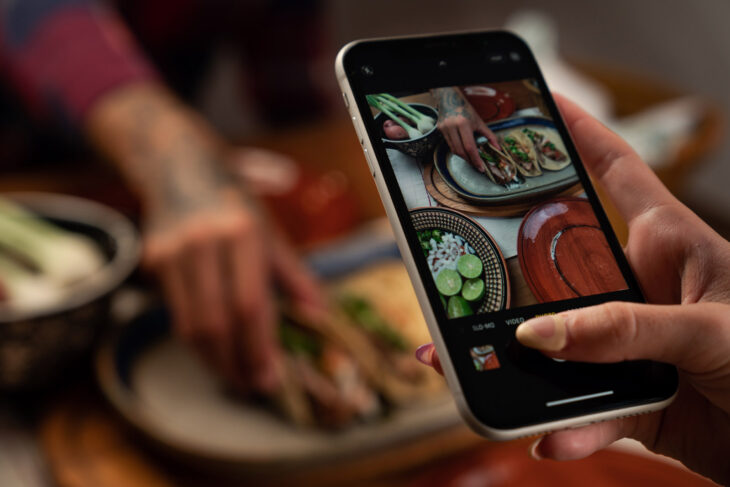 a foodie takes a picture of a plate of tacos