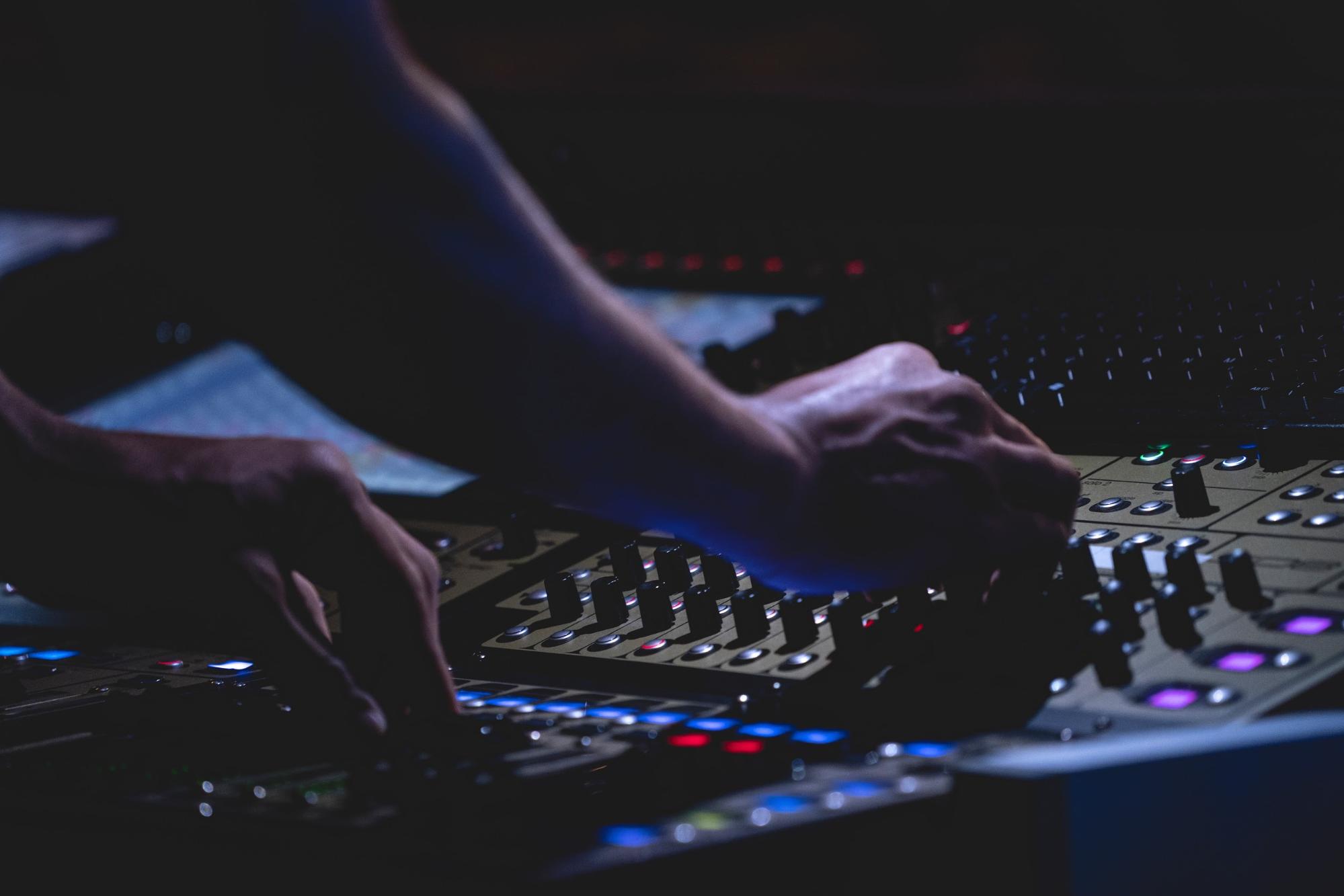 A DJ adjusting some settings during a live performance.