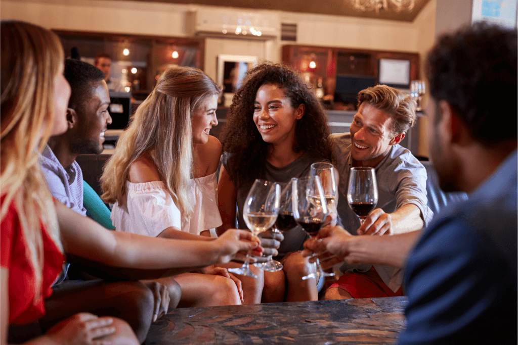 A group of people cheersing wine glasses