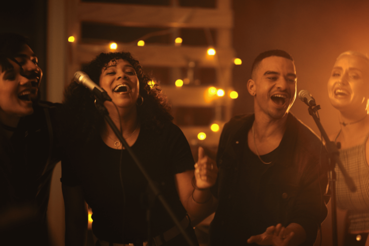 four people singing karaoke at a club in vegas