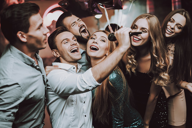A group of people singing at a Las Vegas karaoke bar 