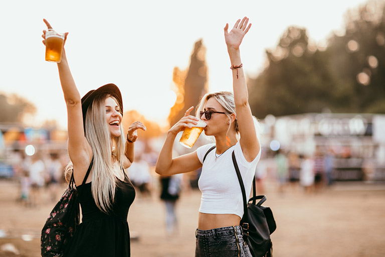two friends drinking beers at a festival in Vegas