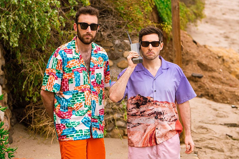 Two Friends posing in sunglasses and colorful outfits 