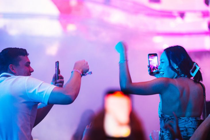 two friends fist-bump at an EDM festival