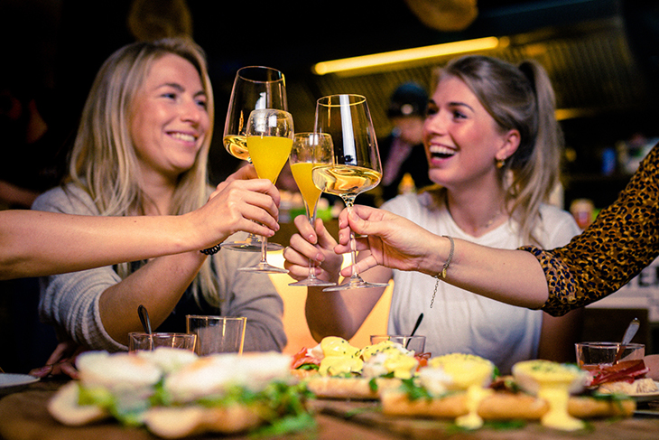 Girls having fun while drinking mimosa during brunch at Las Vegas